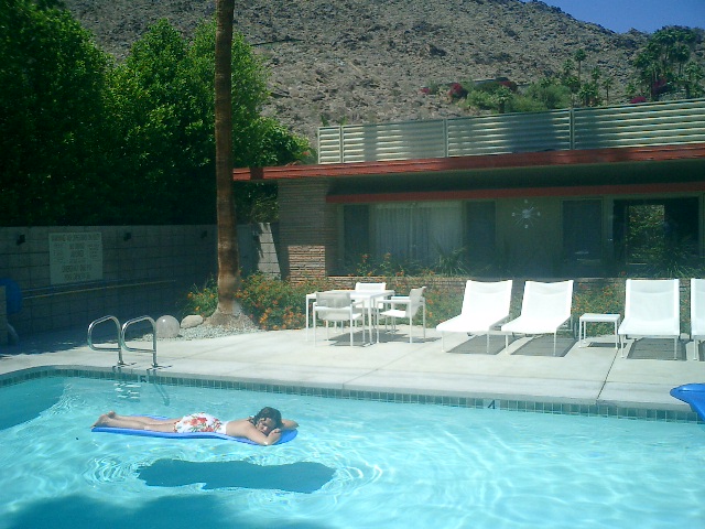 Monica relaxing in the pool at space age oasis known as the Orbit In, 5/8/04